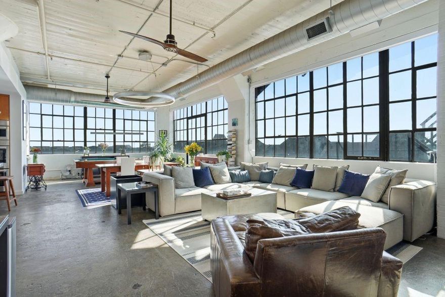 Enter this stunning, fully renovated loft and enjoy the perfect blend of history and modern, high-end finishes.  Perfectly situated in downtown Dallas between Deep Ellum and the Farmer’s Market, this gorgeous 2-bedroom, 2 bath loft with powder room features downtown views from every room.   The gallery entrance to this corner unit features a powder room and coat closet and leads to the expansive, loft-style living-dining room with massive walls of windows which flood the space with light and provide downtown views to the west, as well as southern exposure and light.  Perfect for entertaining, the open-concept chef’s kitchen features stainless steel countertops and breakfast bar, double ovens, Sub Zero refrigerator, and the home also includes a separate bar area with custom concrete countertops and its own refrigerator and freezer drawers.    The extraordinary primary bedroom suite offers stunning downtown views and includes a flexible office, exercise, sitting area, hardwood flooring, large closets, built-in ceiling audio, concrete countertops, a massive shower with 3 showerheads, and a private toilet-bidet area.  The spacious secondary bedroom is perfect for guests or everyday use.  
 
One of the few remaining units in this historic, landmarked building with its original, 100-year-old concrete factory floors preserved intact, this home has otherwise been fully renovated and features modern, LED lighting throughout, brand new HVAC ($34K in 2025), new hardwoods in the primary suite (2023), fully renovated bathrooms with custom concrete countertops (2023), new bar and Bosch kitchen appliances (2023), automatic blinds with remote, tankless hot water, full size washer-dryer, whole-home audio, new electrical (2022) and all windows re-glazed (2020).
 
Offering a true downtown lifestyle, this historic, landmarked building celebrated its centennial in 2025 and features a fitness center, concierge, beautiful rooftop swimming pool, observation deck, hot tub, jogging track