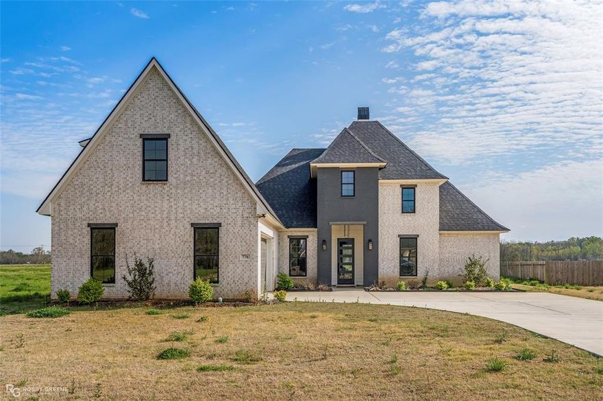 Discover elevated living in this new construction home located in the Duckwater Landing subdivision of Bossier City. Designed with intention and built with precision, this home showcases superior craftsmanship, timeless finishes, and carefully selected details throughout. The open-concept layout is both functional and stunning, featuring wide-plank white oak flooring, custom cabinetry, and designer lighting throughout. A chef-inspired kitchen serves as the centerpiece of the home, complete with a quartzite island, full-height backsplash, and premium finishes—perfect for both everyday living and upscale entertaining. Expansive windows invite natural light into every space, while thoughtfully designed living and dining areas create a seamless flow. The remote primary suite with ensuite bath offers a private retreat with spa like amenities, creating a serene escape within the home. Outdoors, enjoy a fully equipped kitchen designed for entertaining, relaxing evenings, and effortless indoor-outdoor living. This home is a true statement of luxury, comfort, and craftsmanship in one of Bossier City’s most sought after communities. Schedule your showing today!