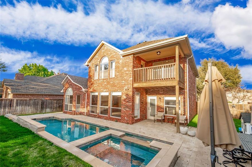 Welcome to 2701 Stone Creek Drive in the heart of Flower Mound! Ideally located just moments from Stone Creek Park, this home offers easy access to playgrounds, scenic bike and walking trails, and is zoned to highly sought-after Flower Mound schools. Inside, you’re greeted by a spacious living room featuring a stunning connected fireplace that creates a warm, inviting flow into the private primary suite downstairs. The primary retreat is a true escape, complete with its own fireplace, jetted tub, separate shower, dual sinks, and a generous walk-in closet. The main level also offers a beautifully updated kitchen with granite countertops, a stylish backsplash, and upgraded wicker lighting, all opening to the main living areas. A front dining room provides the perfect space for hosting, along with a convenient half bath for guests. Upstairs, you’ll find three additional bedrooms, a full bath, and a versatile flex living space—ideal for a game room, office, or media room. Step out onto the balcony to take in views of the stunning backyard. Out back, enjoy your own private oasis featuring a covered patio and a gorgeous pool—perfect for relaxing or entertaining year-round.
