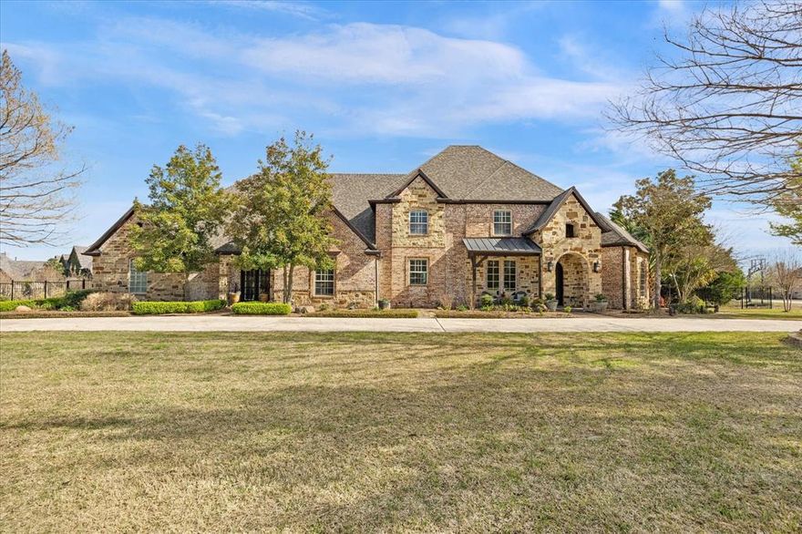 This beautiful home located in the Ridge subdivision is located only 30 minutes away from downtown Dallas.  This estate style custom stone and brick home is situated on 1.6 lushly landscaped grounds overlooking greenbelt with breathtaking views features gated driveway, 4 car garage with lots of cabinet and work space, sparkling saltwater pool with water feature and beach entry, large covered patio extension and outdoor fireplace and living area with bar countertops & seating and refrigerator.  Inside,  entry features gorgeous formal dining area with iron chandelier, tiered crown molding, handscraped hardwood floors and sitting room perfect for conversing with friends, reading a book or enjoying morning coffee. Beautifully updated kitchen is a chef's dream and includes quartzite counters, stainless steel commercial grade Dacor stove, large island perfect for meal prep, large bar area, coffee bar, and oversized Sub zero refrigerator & freezer, warming drawer and icemaker.  Kitchen opens onto spacious breakfast area with iron chandelier and large living room area with cast stone fireplace.Downstairs primary suite features sitting area and large updated primary bath with tub and walk in steam shower, walk in his and her closets.  Downstairs guest suite offers bedroom with access to full bath with shower.  Office area, bonus room, and workout room plus full bath complete the downstairs.  Upstairs, gameroom includes snack bar and overlooks expansive backyard, media room, and 3 additional bedrooms with walk in closets. Large room with stained glass doors can be 2nd primary bedroom or flex space.  Two large walk in storage areas are also located upstairs along with upstairs balcony overlooking pool area and backyard. Solar panels are included with home and are paid in full. Small storm shelter also located in the home!  This home is a must see!