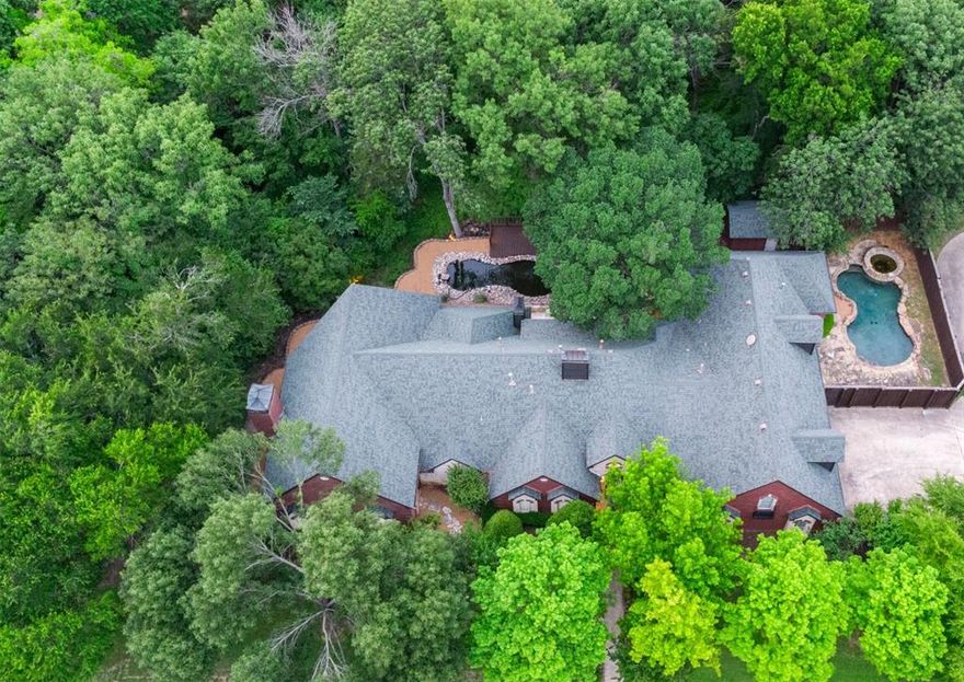 PRICE REDUCED. No HOA! Hidden gem in the heart of Garland, TX. Spacious 6,515 sq ft estate nestled on a serene 1.89-acre lot near the vibrant Firewheel area. beautiful creek side property. Offering unmatched privacy and natural beauty, this property is ideal for multi-generational living, a private residence, or a potential income-producing VRBO, Airbnb. Step inside to find 4 bedrooms and 4 bathrooms, with a layout designed for comfort and flexibility. The expansive kitchen opens to a sunlit living area and breakfast nook, all with stunning views of the peaceful creek and mature trees. The primary suite is a luxurious retreat featuring its own fireplace, spa-like bath with jetted tub, and oversized closets. A private guest suite on the main level adds convenience, while the impressive 1,600 sq ft great room offers endless possibilities — complete with a stone fireplace, spiral staircase to a loft with breathtaking creek views, and space for an office or future living suite. Entertainment and wellness abound with a game room, fitness room, media room, and ample storage. The oversized 3-car garage features porcelain tile flooring and a large driveway for extra parking. Outdoors, enjoy a spectacular 14,000-gallon koi pond with a charming bridge and deck with built-in gas grill — perfect for gatherings. A separate backyard oasis includes a sparkling pool and spa. Located with easy access to Plano, Richardson, Murphy, Wylie, Rockwall, and major highways to downtown Dallas, this PROPERTY offers the perfect blend of tranquility and convenience.