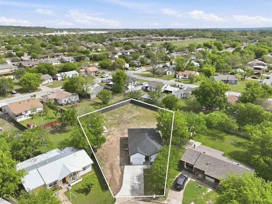 Beautiful New Construction Home featuring 3 Bedrooms and 2 Bathrooms, situated on a spacious 0.401-acre cul-de-sac lot in Mineral Wells! This thoughtfully designed property offers modern upgrades throughout, including 9-foot ceilings and tile flooring throughout the entire home, no carpet, featuring a glossy finish that enhances natural light and creates a bright, open feel. The kitchen showcases quartz countertops, contemporary cabinetry, and a functional open-concept layout that flows seamlessly into the living and dining area, perfect for everyday living and entertaining. Both bathrooms feature upgraded tile showers with stylish finishes, and the primary bathroom includes a solid tile shower base for a more custom, high-end feel. Exterior highlights include a large backyard with plenty of space to enjoy, plus a beautifully finished stone and concrete patio—ideal for outdoor gatherings and ready for a future cover or pergola. The home also offers a 1-car garage with an extended driveway accommodating up to 2 vehicles. Conveniently located near major highways including US-180 and TX-337, providing easy access to Weatherford, Fort Worth, and surrounding areas, while still enjoying the charm and tranquility of Mineral Wells. Don’t miss this opportunity to own a move-in ready home with quality upgrades and a large lot! Owner financing available with flexible terms. Lot size per survey.