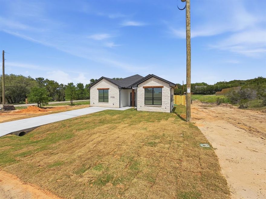 Welcome home to this adorably cute new construction home proudly built with skill, care, and craftsmanship by a local Granbury builder. This new home has everything included! Construction was completed April 2026 and this home is move in ready. 3 full bedrooms, 2 full baths, 1300 square feet, a very large and open living room, open kitchen, full size utility area, and split bedrooms. Interior of this home is simply amazing! Wood look tile flooring throughout with no carpet, ceiling fans in all bedrooms, quartz countertops in the kitchen and both bathrooms, convenient foot locker area with cabinets by the front door, a perfect kitchen with full stainless appliances. Refrigerator, cook top stove, dishwasher, and built in microwave are all included. Kitchen also features ample and elegant white cabinets and a walk in pantry. Don't miss the full size utility area with built in cabinets! Primary bedroom and primary bathroom are simply amazing! Walk in closet in the primary bedroom and a dream ensuite primary bathroom that includes quartz countertops, double sinks, and an oversized walk in shower. Primary bathroom flooring is beautiful white quartz. Guest bath also features quartz countertops with built in cabinets and shelving. Bedrooms 2 and 3 are the perfect size for the kids or a home office. 2 inch white wood faux blinds on the windows top off the elegance of this new home. Exterior is just as amazing. Full size concrete driveway, gutters, full sod front and back yard, Austin stone and siding construction, and a wood privacy fence around the back yard. Community features a community pool, park, clubhouse, Lake Granbury access, and a boat ramp. Conveniently located just outside the City limits yet close to everything Granbury has to offer.