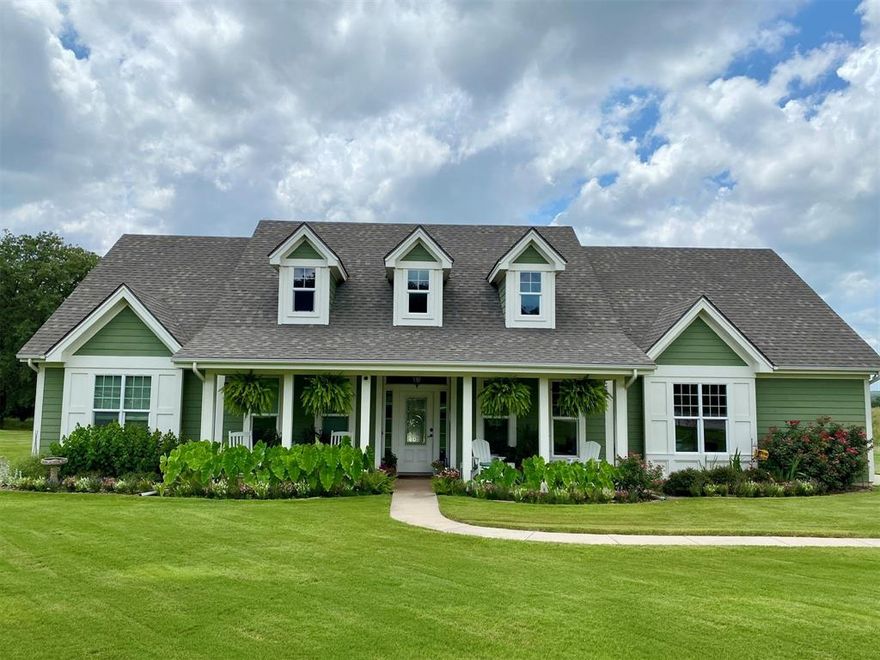 Primarily one-story home on just over 3 acres provides ideal space for hobbies, equipment, gardening, or simply enjoying the privacy and views around the lake. Adjacent 3 acre tract also available (MLS #20877045). Purchase both properties together for approximately 6 acres total. This energy efficient home has 60 OWNED solar panels and battery backup designed to offset most, if not all, of the electric bill. All main living areas and bedrooms are downstairs with only a private guest suite and full bath upstairs. This 4 bedroom plus office, 3.5 bath home offers 2,550 sq ft with high ceilings, oak flooring in the living and dining areas, tile in the kitchen, baths and halls, with vinyl picture windows throughout. Living room features a gas fireplace with granite surround. Kitchen includes custom maple cabinetry and granite countertops and opens to both the living and breakfast area. Dedicated office with built-in desks. Private primary suite with safe room & storm shelter closet. Two bedrooms share a Jack & Jill bath with granite countertops, while the upstairs bedroom and full bath offer a private space ideal for guests or multigenerational living.  Walk-in floored attic offers excellent storage. Structural Insulated Panel construction for added efficiency. Central vacuum. New AC in 2023 and upstairs mini split in 2022. Roof replaced in 2025. Backyard designed for entertaining with resort-style pool featuring infinity edge, fountains, slide, lighting and new filter (2025), upper and lower concrete pool decking, covered back porch, fenced yard, raised garden beds with drip irrigation and deer fencing, and sprinkler system with Tifway 419 Bermuda grass. Additional features include fiberglass tornado shelter that will seat 6, greenhouse with a 1 car garage, an additional detached 2 car garage & workshop, RV pad with electric hookup, concrete driveway, and water well for irrigation. Property includes ownership in the community lake lot that is stocked with fish.