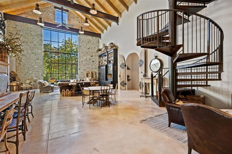 Masterfully designed Belgian Chateau gated and purposefully situated on 3 AC Estate lot enveloped by beautiful mature trees. This home gives a nod to a soft industrial feel with large steel framed windows and doors that blur the lines between indoor and out. 4 BR, 3.5 BA open floorplan, you'll see imported European tile, stained concrete floors, ornate bluestone features and custom antique doors and shutters. Glass breezeway leads to primary suite overlooking a private, picturesque garden oasis also has steam shower and fireplace. Ample storage, 4 garage stalls and an impressive 800+sq.ft. studio loft apartment. This home won HGTV's Ultimate House Hunt 2023 Kitchen Category! Custom Thermador vent-a-hood, range, sub zero refrigerator, leathered granite countertops, distinctive custom cabinetry perfects a fusion of beauty and functionality. Host elegant evening events by opening the steel doors to the courtyard lit by unique antique fixtures and splash pad creating the perfect ambiance.