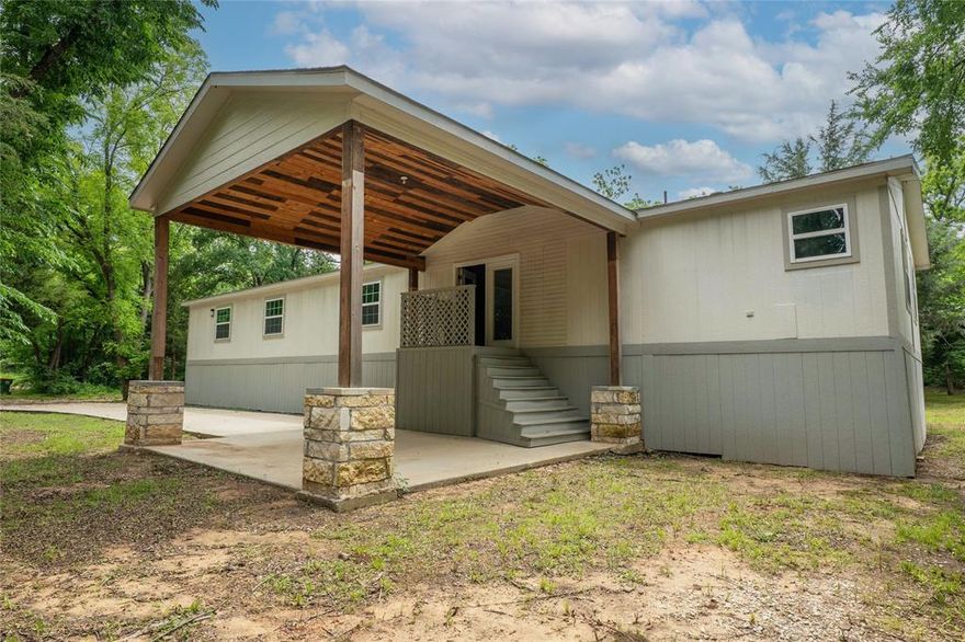 Beautiful Double Wide Mobile Home with Land! This spacious home offers 5 bedrooms and 3 full bathrooms with an open concept floor plan perfect for comfortable living. Enjoy two living areas, one featuring a cozy fireplace—ideal for relaxing evenings. The large, well-equipped kitchen includes plenty of cabinet space and granite countertops, perfect for cooking and entertaining. Bedrooms are generously sized, and the primary suite boasts a beautiful bathroom with a soaking tub and a walk-in closet. Some rooms also feature ceiling fans for added comfort. Step outside and enjoy the peaceful surroundings, surrounded by lush greenery—a perfect retreat where you can breathe in peace and tranquility. And best of all, you're just 10 minutes from Historic Downtown Mansfield! Don't miss this hidden gem!