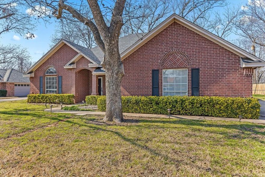This is a lovely, well kept home in prestigious golf community, Pecan Plantation. It is conveniently located near the front gate and has a wonderful, serene view from the screened-in back porch of the treed privately owned property behind. Some features include granite in Kitchen, large pantry, large master bath with separate shower and garden tub and large secondary bedrooms. The laundry room has a sink, lots of cabinet and counter space and window for natural light. There's a beautiful view out windows on back. Also features an exterior roll-down screen for dining room window, wide gate, and a patio with a fire pit in large, fenced backyard. Community features 2 golf country clubs, restaurant, marina and many other amenities. HOA monthly dues include trash.
