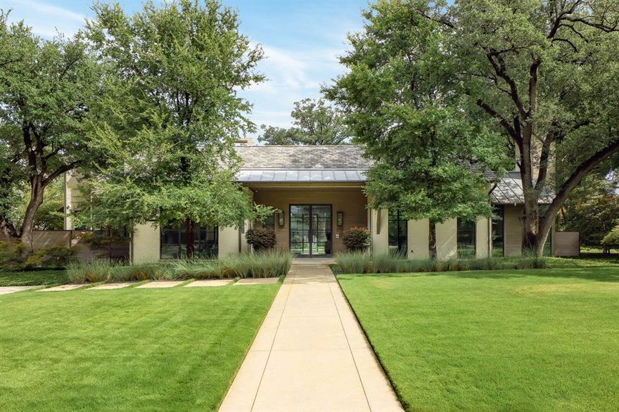 Sited on one of the prettiest corners in Greenway Parks, this custom home was completed in 2017.Meticulous planning by Mark Hoesterey of SHM Architects and excellent craftsmanship by Joe Kain Homes created a resort type feel in the heart of Dallas.Walls of windows overlook the pool and large front and back lawns.Entry with concrete floors and reclaimed beam ceiling leads to a private office that includes a seating area with fireplace and adjacent temperature controlled wine room.Entry also leads to a spacious dining room and bar area with icemaker, wine storage.Kitchen and family room with 11 foot ceiling has island,Wolf Range, Subzero refrigerator, refrigerator drawers, and expansive windows.There is a prep area that includes a second dishwasher, wine storage, food storage. and a office.Off the family room one finds the ultimate laundry and craft room. Spacious with room for a center island for projects, upper and lower cabinetry for incredible storage and huge countertop area. The first floor primary suite includes a cozy sitting room and space for a sitting area in the bedroom. Both rooms overlook the pool and large yard. The primary bath has dual sinks, separate tub and shower, private water closet, and spacious closet with great builtins.Upstairs there are 3 bedrooms and 2 full baths. Two of the bedrooms share a connecting bath and one room is being used as an upstairs living area. The third bedroom has a private bath with tub and large sink area.The covered patio and pool are viewed from many vantage points in the home. The patio has a double sided fireplace that separates a seating area from an eating area. The pool with tanning ledge and adjacent firepit and seating creates a peaceful retreat. There is a builtin barbecue area as well.At the rear of the property there is a 2 car garage and carport that can accommodate 3 more vehicles. Above the garage there is a room and bath that can serve as guest quarters or office.