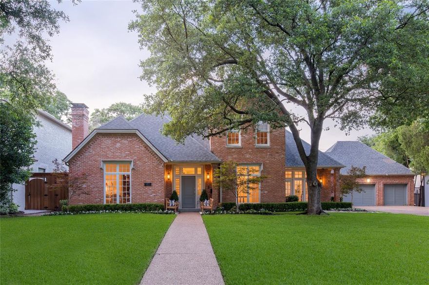 Nestled on .41 acres of manicured grounds, this traditional Preston Hollow home exudes elegance. The flowing floor plan welcomes you with spacious formals flanking the entryway, accompanied by a private study with impeccable wood craftsmanship. The great room, adorned with a warm fireplace, wet bar, and a wall of windows, offers a serene view of the backyard. The gourmet kitchen showcases dual ovens, a gas stovetop, a butler's pantry, and a stretching island, adjoined with the most charming breakfast room and an array of windows. The convenient primary suite provides ample space for a sitting area and features a spa-like bath with double vanities, an oversized tub, and a generous walk-in closet. Upstairs, a sprawling game room awaits along with three well-appointed bedrooms and two bathrooms. Escape to the private backyard retreat, where an expansive covered patio invites relaxation, and a sparkling pool and spa await, surrounded by the enchanting ambiance of a park-like setting.