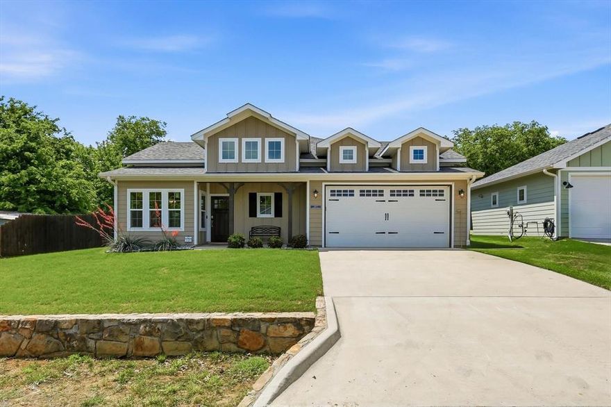 Welcome to this little slice of perfection in Lake Dallas! Offers plenty of room on the side yard for a boat or RV with electric gate!! This craftsman style 3 bedroom home is LOADED with high end, quality, custom finishes throughout! Tucked away on Wilson street where every house has character, this home welcomes you with eye catching curb appeal the moment you drive up! The covered porch encourages time out front. The solid wood door invites you into the open family room and kitchen complete with luxury vinyl plank flooring, plenty of windows offering natural light and electric blinds, fireplace plus mantel, kitchen island bar with granite countertops, gas range, stainless steel appliances, coffee bar, custom wood cabinetry, plenty of kitchen storage and designer lighting fixtures throughout. 3 bedroom and 2 bathrooms offer plenty of room for guests or family. Climate controlled garage finished out with attention to detail and epoxy flooring. Tankless water heater a bonus! Spend time under the covered patio out back. New fence plus electric fence for privacy and security for a boat or RV. 5 minute walk to Lake view marina on Lake Lewisville. Quick access to major roads, restaurants and shopping!