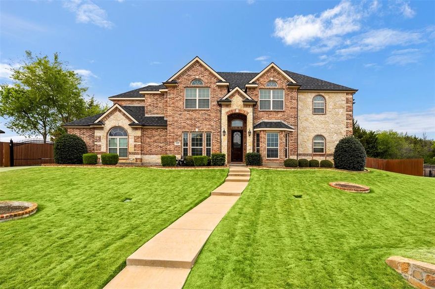 WOW! This stunning two-story home offers the perfect blend of space, comfort, and style, ideal for a large family that loves spending time together while enjoying the luxury of a peaceful retreat. Nestled within a secure, established gated community, this home provides both privacy and peace of mind. A dedicated office with a closet offers the flexibility to serve as a fifth bedroom, making it perfect for growing families or multi-generational living. Step inside and experience warmth and elegance at every turn. Whether you’re unwinding upstairs in the private home theater, accessed through charming barn doors, or gathering in the oversized living area featuring a cozy corner fireplace, every space is designed for comfort and connection. Abundant natural light fills each room, beautifully highlighting the rich flooring throughout the home. Architectural details such as crown molding, recessed ceilings, and graceful arched doorways add timeless character and sophistication. The spacious primary suite offers a true escape, complete with a luxurious jetted garden tub, perfect for relaxing at the end of the day. The gourmet-style kitchen is a chef’s dream, featuring dual ovens, generous counter space, and a convenient breakfast-coffee bar, ideal for both everyday living and entertaining. Storage is never an issue, with ample cabinetry and thoughtfully designed spaces throughout. Curb appeal shines with eye-catching stonework and easy-to-maintain landscaping, including lush Zoysia grass in the front yard. The backyard offers plenty of space to enjoy, along with a versatile air-conditioned doghouse or bonus storage area equipped with a security camera. Additional storage is available in the Tuff Shed, complete with built-in shelving. 
This home is truly beautiful inside and out, offering comfort, functionality, and style in every detail.