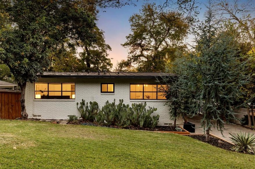 Tucked away on a quiet cul de sac in coveted Ravinia Heights, this stylish mid-century modern is your Palm Spring oasis in the heart of Dallas. Rolling hills, mature trees, and winding roads lead you to this sanctuary. Renovated in 2018, this chic abode boasts three spacious bedrooms and two sleek bathrooms. From the moment you enter, you're welcomed by rich hardwood floors and stunning vaulted ceilings that open up to a bright and airy living space. The seamless open floor plan effortlessly connects each area, perfect for modern living. Slide open the glass doors to discover your outdoor oasis, complete with a backyard deck, an above-ground pool, and twinkling string lights, setting the scene for unforgettable gatherings. Just a stone's throw away from the eclectic Bishop Arts District, picturesque Kessler Park, and the bustling energy of Downtown Dallas.