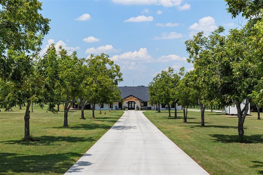 Welcome to your dream modern farmhouse in Granbury, Texas — where country charm meets modern luxury. Built in 2024, this home was designed for comfort, entertaining, and peaceful living on 12.87 beautiful acres backing up to a creek.

Step inside and fall in love with the chef’s kitchen, featuring a Z-Line 10-burner gas range with double ovens, built-in oven, convection microwave, pot filler, and granite island with dual sinks. The butler’s pantry and custom wet bar make this kitchen as functional as it is stunning.

The primary suite is your private retreat, complete with a large tiled walk-in shower, dual vanities, and a generous closet that connects to the utility room. Both the primary and second bedrooms open to the back porch, perfect for morning coffee or watching Texas sunsets.

Throughout the home, you’ll find LVP flooring, a cozy wood-burning fireplace, double steel front doors, and plenty of natural light. Smart, efficient systems include a dual-fuel HVAC with smart thermostats, 26K Generac generator, tankless water heater, 500 gallon propane tank and Class 4 hail-resistant roof.

A 25x25 studio and climate-controlled attic with fixed stairs offer flexible space for work or hobbies.  The 45x60 insulated shop features a full bath, washer & dryer hookups, multiple outlets, and two 50-amp RV hookups with water and sewer. A 20x30 equipment shed adds extra storage, and the double-wide manufactured home is perfect for guests or rental income.

If you’ve been searching for a modern farmhouse for in Granbury that combines luxury, functionality, and the peace of country living — this is it.
