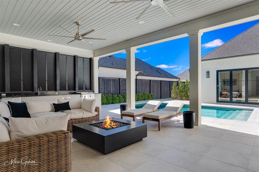 A rare opportunity to own a single-owner, custom-built home thoughtfully designed for refined luxury living. A wooden courtyard entry door welcomes you with a sense of privacy and arrival reminiscent of an exclusive destination, while the quiet street setting, clean lines, crisp details and timeless finishes establish a polished, sophisticated first impression. The single-level home features engineered white oak wood and tile throughout, with no carpet. Exceptional floorplan. A spacious living room features floor-to-ceiling windows and fireplace, offering beautiful views of the outdoor living area & pool while filling the interior with abundant natural light. The space flows seamlessly into the Kitchen and Living. The Chef’s Kitchen anchors the home with GE Monogram appliances, a custom waterfall-edge quartzite island, black granite countertops, a marble backsplash with brass inlay, pot filler, floating shelves and custom vent hood. A sculptural gold and nickel chandelier highlights the island, while a built-in dry bar with wine fridge enhances entertaining. The Dining flanks the Kitchen, offering effortless connection for gatherings large and small. Spacious utility with storage. Drop station off the oversized garage. Wallpapered Powder Room. The private Master Suite is a serene retreat with pool views and a spa-inspired bath featuring a luxurious soaker tub, extensive built-in storage, mirrored-front cabinetry, and a spacious custom closet with chic carpet. Each additional bedroom includes a private en-suite bath, including a casita-style third suite off the courtyard—ideal for guests or extended stays. Outdoor living shines with a fully equipped kitchen featuring Blaze appliances, beverage fridge, gas grill, outdoor TV & a custom gas fire pit reminiscent of those found in destination properties. Enjoy the Provenance lifestyle with walkable or golf-cart access to Rhino Coffee, dining, events & amenities including a neighborhood pool, parks, clubhouse & gym.