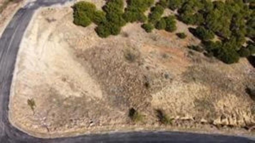 Build your dream home or weekend escape on this exceptional one-acre homesite nestled at the top of a hill in the desirable Hills Above Possum Kingdom Lake. Tucked within a gated northern Hill Country community, this property offers a peaceful, private setting highlighted by breathtaking views of Possum Kingdom Lake and sweeping countryside vistas. The lot features natural rock formations, elevation changes, and native trees that add character and privacy, while still offering a desirable, relatively level area that provides an ideal building site for a thoughtfully designed custom home perfectly positioned to capture stunning lake views, dramatic sunsets, and the beauty of the surrounding Hill Country landscape.

Water and electricity are available at the street, making the property ready for your future plans. There is no requirement to build immediately, allowing you to move at your own pace and select the builder that best fits your vision. CCRs require a minimum 2,500 square foot residence. When the time comes, the seller does have thoughtfully designed home plans available that may be customized if desired.

Lot ownership includes access to all neighborhood amenities, including boat storage, a community boat ramp and dock, clubhouse with pool and fitness center, fishing pond, lake access, picnic area with cabin, nature trails, and more than 20 miles of private gated roads—offering the perfect balance of lake recreation and quiet country living. Enjoy the freedom of acreage living with resort-style amenities, breathtaking scenery, and the relaxed Possum Kingdom Lake lifestyle, all less than two hours from the DFW Metroplex. Contact the listing agent to discuss build-to-suit options or available builder opportunities.