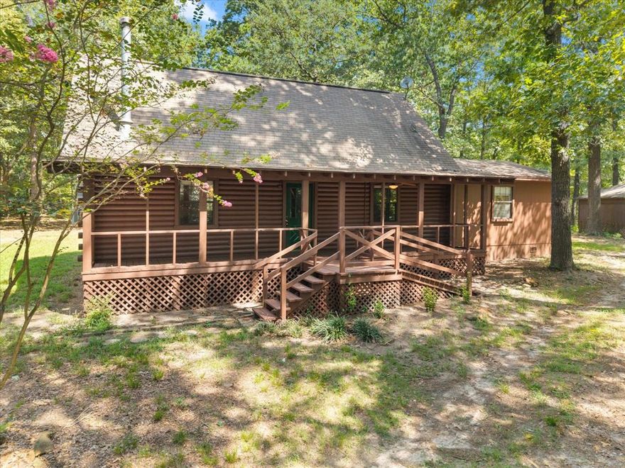 Discover rustic elegance in this unique log cabin home, perfectly tucked away on two wooded parcels totaling approximately 5 acres in the highly sought-after Horseshoe Bend community of East Texas. This 2-bedroom, 2-bath home offers an inviting open-concept kitchen and living room, complete with a cozy wood-burning stove and soaring ceilings that lead to an upstairs loft—ideal for an office, or additional living space. The private master suite features a serene patio, perfect for enjoying peaceful mornings surrounded by nature. Outdoors, you’ll find a 24x12 shop with two additional lofts for storage, plus a two-car carport with wood siding and a shingled roof that blends seamlessly with the property’s rustic charm. Located near Horseshoe Bend Lake, you’ll find easy access to fishing, recreation, and the tranquility of lakeside living—all while enjoying the privacy of your own wooded retreat. Whether you’re seeking a weekend getaway or a full-time escape, this one-of-a-kind log cabin offers the perfect balance of comfort, character, and country living.
