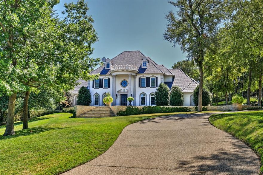 Welcome to your new home in this magnificent remodeled Antebellum Estate in the guarded & gated Mira Vista community. Enter the spectacular foyer with soaring ceilings, marble floors, and stunning custom chandelier. The kitchen has two islands with a sizable breakfast bar, professional SS appliances and marble countertops. Primary bedroom with relaxing sitting space, fireplace, and stunning views; freestanding tub, two vanities, and custom closet in the primary ensuite. Handsome study with rich woodwork and a secondary bedroom with ensuite are also located on the main floor. Two of the three secondary bedrooms are concealed behind a hidden bookshelf, and all three feature ensuite baths. The second story is finished with a second living space and massage room. Extra-large 3-car garage with a parking pad. The outdoor living area features a sizable pool with a turf surround, stone fireplace, and outdoor grill. Beautiful patios and balconies provide picturesque views of the property.