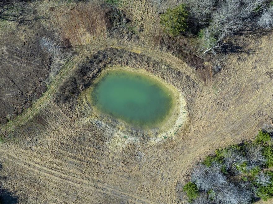 This 12-acre tract features gently rolling terrain with over 20 feet of elevation change, creating a highly usable landscape. The property includes a diverse mix of hardwoods and native trees, including post oak, live oak, cedar elm, winged elm, and hackberry. Scattered clearings provide ample space for grazing, food plots, or potential homesites, while denser wooded areas offer excellent wildlife cover and added privacy. Soils consist primarily of sandy loam and Blackland clay. A medium-sized pond is located on the tract and has proven sufficient for both wildlife and cattle. Lavender Acres is not currently fenced, as the seller anticipates the possibility of a buyer purchasing additional acreage. The seller is open to splitting fencing costs, dependent on the terms of the offer. Electricity is available at the road or on the neighboring tract. Nearby water wells range from approximately 110 to 550 feet in depth and typically produce yields between 5 and 40 gallons per minute.