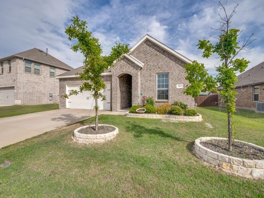Modern living meets country charm in Caddo Mills! This 4 bed, 2 bath home offers quick access to I-30 and is located in a newer community with pool, pond, walking trails, parks, and playground. Inside, you’ll find a thoughtfully designed split-bedroom layout with an open-concept living space and a sleek modern decorative fireplace. The kitchen features quartz countertops, large island, gas range, and walk-in pantry—perfect for everyday living and entertaining. Enjoy added efficiency with a tankless water heater. Spacious secondary split bedrooms offer flexibility for guests or a home office. Relax on the covered front porch or unwind on the back patio. Zoned to top-rated Caddo Mills ISD. A perfect blend of comfort, style, and community amenities with a peaceful country feel close to city conveniences.