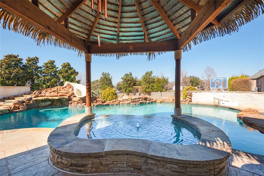 SPECTACULAR custom built home on one acre in sought after PROSPER ISD. Built home by Dave R Williams. Truly your own private oasis in the backyard yard with a sparkling diving pool and tiki covered spa, water slide, outdoor cooking area, and beautiful landscaping. Start planning your summer parties now. Upgrades include gorgeous hardwood floors, wood beams on vaulted ceilings, Plantation shutters, additional built ins and an amazing walk in pantry. The custom office also has beautiful wood built ins. 4 CAR GARAGE and extended driveway allows for a lot of parking. Room for pets and play equipment. Close to all major shopping and access to DNT but totally feels like country living! Experience the best of both worlds.  This is your chance to have it all.