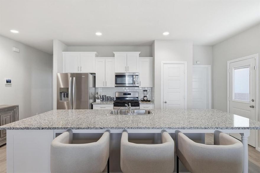 Welcome to this beautifully designed 3-bedroom, 2.5-bath townhome offering 1,590 sq ft of modern living in a gated community. Built in 2024, this home combines contemporary finishes with a smart layout that makes everyday living both comfortable and stylish.

Step inside to discover ceramic plank tile flooring throughout the main level, creating a sleek and low-maintenance foundation for the open-concept living space. The kitchen is truly the centerpiece of the home, featuring a large statement island, gas range, and generous counter space—perfect for cooking, gathering, and entertaining.

Upstairs, a versatile loft area provides additional living space that can easily serve as a home office, media nook, or kids’ play area. The spacious primary suite offers a relaxing retreat, complete with a large walk-in closet and a beautifully finished bathroom featuring double vanities and a subway-tiled glass shower.

Two additional bedrooms provide flexibility for guests, family members, or workspace needs.

Enjoy the peace and privacy of gated community living while still being conveniently located near shopping, dining.