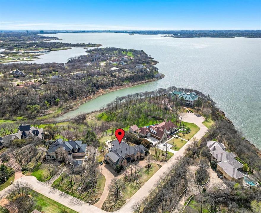 UNMATCHED PARADISE PERFECT FOR ENTERTAINING on a 1+ ACRE WATERFRONT LOT in an EXCLUSIVE GATED & GUARDED COMMUNITY! Exquisite finishes include handscraped wood floors, plantation shutters, intricate moldings, wood-beamed ceilings, a wine cellar, remodeled bathrooms, 2 large balconies & a 3rd floor game room. Host in the chef's kitchen offering quartz counters, high-end Monogram appliances, glass tile backsplash & an island with a second sink. Pamper yourself in the luxurious primary suite boasting a see-thru fireplace, sliding barn door, oversized frameless shower, separate granite vanities, jetted tub & recent carpet. Enjoy the outdoors in your scenic backyard showcasing a PebbleTec pool & spa with a cascading waterfall, an outdoor living area with a fireplace & built-in grill, pristine landscaping, mature trees & a putting green. Make great use of the oversized 3 car garage with epoxy floors perfect for XL vehicles. Nestled on a quiet cul-de-sac street where deer sightings are common!