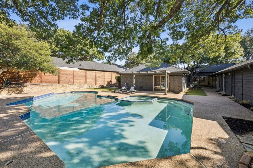 Reimagined and renovated modern dwelling in Merriman Park on a spacious, elevated lot. With its custom u-shaped design, this 70's contemporary with mid century elements features a wall of windows with dramatic views of a tall mature oak tree and courtyard. Spring and Autumn weather can be enjoyed from the Kitchen, Main Living Room, and Primary since this dwelling features 5 sliding glass doors; allowing breezes to permeate throughout. The entry features an enclosed side atrium with spacious windows. Make your way way past the Custom Glass & Steel front door and you will enter a large main living room with 12 foot tall ceilings. Recently installed hardwood floors create a smooth flow throughout. All interior walls have smooth finish with pure white paint. The kitchen is a wonderful space for entertaining & every day functionality; featuring a large breakfast bar and waterfall island capable of seating 4; with Calacatta Quartz Counters. The counters were brought up the walls into the backsplash areas to highlight the dramatic veins in the counters. Stainless steel appliances include a 60 inch wide Forno Maderno Refrigerator and Freezer combo, Italian 8 burner Gas Range, Convection Oven, and Wall Mount Range Hood. The main living boasts a floor-to-ceiling fireplace wrapped in porcelain. The wet bar is adorned in Calacatta Quartz Counters with custom backsplash running up the wall and equipped with a Sink and stainless steel dual zoned Wine Fridge. Each bathroom has been renovated with Marble and Porcelain Tile, LED mirrors, Rain Head Shower Systems, Quartz Counters, & Modern Toilets. The primary bathroom features a 71 inch Freestanding bath tub, Frameless Glass Walk-In Shower, and Custom Closet. The backyard is truly one a kind with an oversized Pool & Spa, raised living & dining areas. The Pool is shaded by a massive oak tree. The backyard also has Synthetic grass, French Drains, and a Horizontal Fence. The Roof was replaced in 24. HVAC replaced in 23 & 24 with Trane.