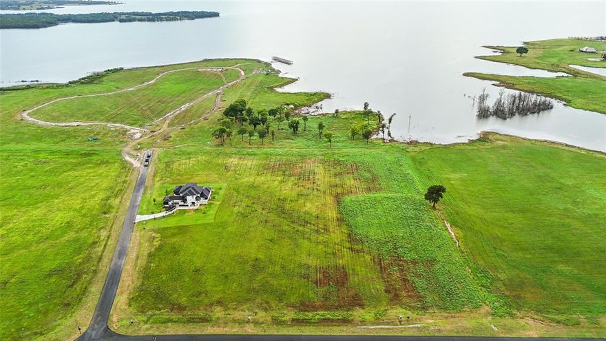 Stunning 1.58 acre waterfront lot ready for you to build to suit your needs. On the shores of Bois D'Arc Lake, this stunning expanse of unimproved land stretches from Shores Road to the Lake and offers an ideal setting to build your dream home! Imagine watching the sunset from your back porch or designing your landscaping around the pristine natural shoreline. This is a one-of-a-kind opportunity is in a private community with a private road! Don't miss out on the beautiful lot! LOCATED AT SHORES AT THE PENINSULA