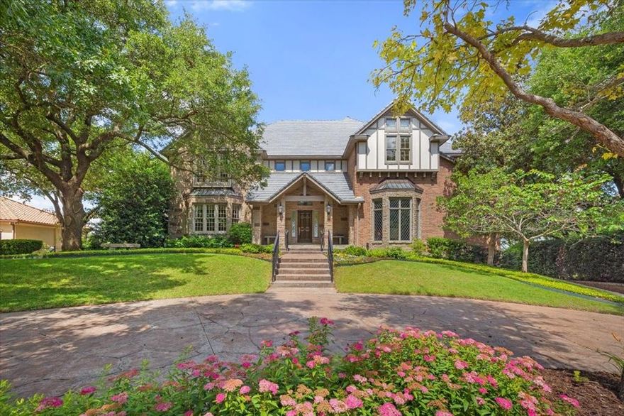 Incredible views abound from this beautiful traditional home of English Tudor style on a quiet, tree-lined cul-de-sac in prestigious gated and guarded Mira Vista. The home overlooks the redesigned and almost completed Mira Vista Golf Course and the horizon for miles beyond.  Walls of windows along the entire back of the home provide natural light to all living areas. The home has recently been artfully staged with many updates. The home offers approximately 8,500 square feet of living area plus an additional 1,000+ square feet of air conditioned flex space as well as garage space for 5 cars with an IV charger. ~~The home consists of four levels, each presenting an opportunity for you to curate the space for your family's lifestyle. The formal living, dining, library, and office are on the first level as well as the kitchen, breakfast area and laundry room which have access to a balcony. ~~A family room on the second level has an interior balcony, a perfect place to display works of art. A unique viewing observation room, where a telescope currently resides, adjoins the family room and provides great star-gazing and relaxation. The second level also encompasses the spacious primary bedroom and luxurious ensuite bathroom. The other two bedrooms, each with ensuite bathrooms, are separated from the primary bedroom. ~~On the lower level, a game room boasts a rustic fireplace created from fossil rock excavated on the building site. A fully equipped exercise room is adjacent to the game room. The approximate 1,000 SF of air conditioned flex space includes an unfinished media room and a workshop. The 5 car garages on this level include an EV charger and a dumbwaiter to carry items from the garage to the kitchen hall on the first level. Please see: About 6908 Ridgewood Dr From The Seller posted in Documents.