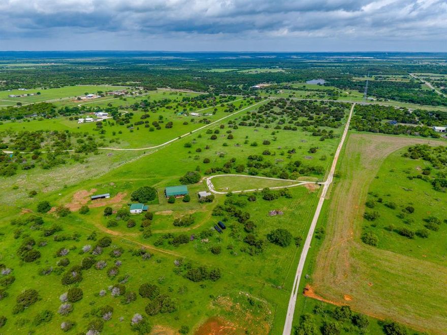 Wide open views, a barndominium-style home, and ready-to-go horse stalls make this 40-acre Graford ranch a turnkey country escape. From the long private drive to the full-length front porch, this property feels like your own escape from the city. 

Step inside to an inviting open-concept layout with rustic finishes and vaulted metal ceilings in the living room. The spacious kitchen is built for everyday living and entertaining, offering crisp white cabinetry, expansive counter space, stainless appliances, and a breakfast bar that flows into the dining area. Multiple bedrooms and a large upstairs flex loft give you room for guests, office, bunk space, or a game room.

Outside, the land is a great mix of open pasture and scattered tree cover—ideal for horses, cattle, or recreational use with plenty of room to roam, ride, or hunt. A versatile workshop provides space for equipment, projects, or storage, and the horse barn includes 3 stalls and a dedicated tack room so you can move your animals in on day one. With easy access to Hwy 254 and the conveniences of Graford, you get peaceful country living without sacrificing connectivity.

If you want a functional ranch setup with character, usable acreage, and room to grow, this 40-acre property is ready for its next owner.