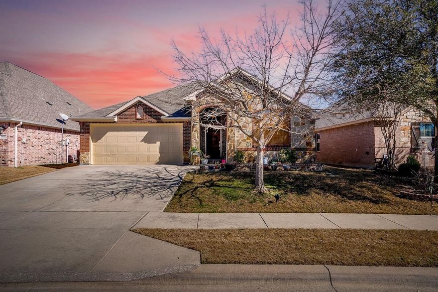 Welcome to this beautifully maintained brick home tucked away in a quaint neighborhood near Lake Worth, offering the perfect blend of comfort and convenience with easy access to I-820 and endless options for shopping and dining. Step inside the inviting foyer and you’re greeted by a cozy living room centered around a charming wood-burning fireplace. The open-concept kitchen and dining area flow seamlessly into the living space, making it ideal for both everyday living and entertaining. Just off the living room, a private office with elegant French doors provides the perfect work-from-home setup. Out back, a covered patio creates a relaxing space to grill, unwind, or enjoy your morning coffee. The spacious primary suite is filled with natural light and features a well-appointed bathroom with a double vanity, walk-in shower, separate soaking tub, and a generous walk-in closet. This inviting home combines thoughtful layout, warm finishes, and a desirable location. Come see everything it has to offer.