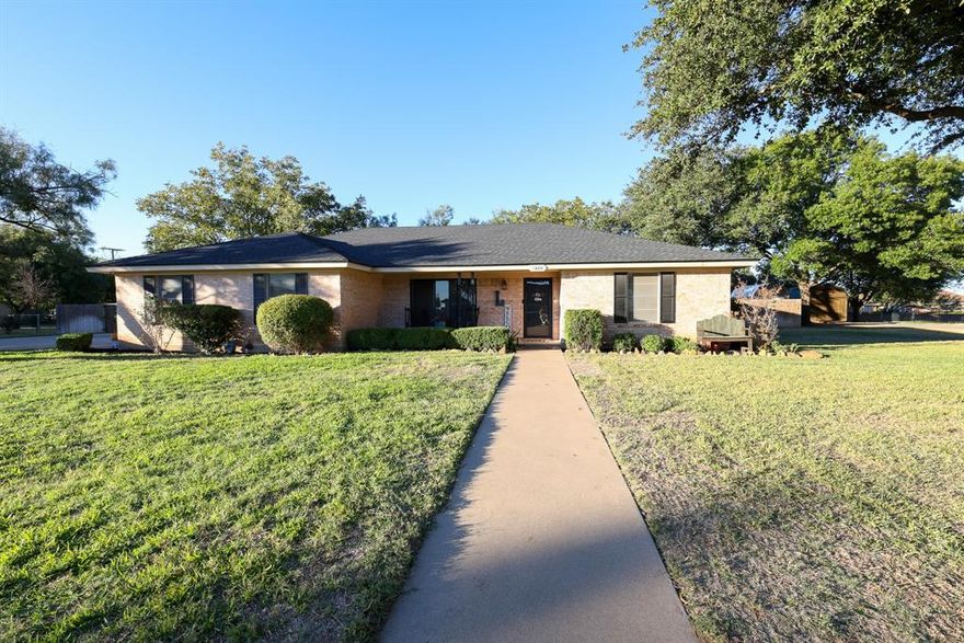 1300 Hillcrest Dr. – Coleman, TX 76834

Beautifully Remodeled 4-Bedroom, 3-Bath Home on a Half-Acre Lot

Completely remodeled and move-in ready, this stunning 4-bedroom, 3-bath brick home sits on an elevated, beautifully landscaped half-acre lot in one of Coleman’s most desirable areas. Every detail has been updated — including a new roof, all new flooring, fresh interior and exterior paint, updated lighting, new countertops, and a gorgeous new primary suite.

As you enter the home, the foyer opens into a large flexible space that can serve as a formal living room, office, or workout room. From there, step into the inviting great room featuring vaulted ceilings with exposed beams, a beautiful fireplace, and an open-concept design that flows seamlessly into the dining area and kitchen. The kitchen showcases white cabinetry, stainless steel appliances, tile backsplash, and durable laminate flooring. The bedrooms are carpeted for comfort, and all bathrooms are finished in stylish ceramic tile.

The new primary suite offers a spacious bedroom and luxurious bath with dual sinks, decorative lighting, and a large walk-in shower. The walk-in closet system provides abundant storage and organization. This split-bedroom layout offers privacy, with three additional bedrooms on the opposite side of the home. One secondary bedroom features its own private three-quarter bath, while the third full bath—with a tub-shower combo and large vanity—serves both guests and the remaining two bedrooms. The updates throughout are beautifully and tastefully done, creating a warm, modern, and inviting home.

Outside, enjoy the expansive, landscaped yard with full sprinkler system, concrete driveway, privacy fencing, large pecan trees, a covered patio for entertaining, and a nice storage building. Located atop the hill in Coleman, this home combines modern comfort, thoughtful updates, and timeless curb appeal — truly a must-see property!