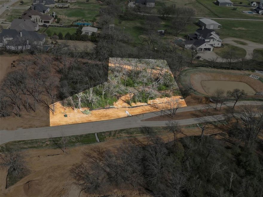 Red Bird Ridge presents a rare opportunity to build a custom luxury estate on one of the most desirable homesites in Argyle. Situated on an elevated 1-acre lot, this exceptional property offers sweeping views of the surrounding landscape, creating a stunning backdrop for a future estate. A pond on the homesite adds a tranquil water feature, enhancing both the visual appeal and overall sense of serenity.

Positioned along the scenic northern ridge, the lot is surrounded by mature post oaks, cedar elms, and native prairie, blending natural beauty with refined living. The elevation of this lot, not only maximizes long-range views but also provides an ideal setting for a thoughtfully designed home with expansive windows, outdoor living spaces, and seamless indoor-outdoor flow.

The generous lot size allows for a wide range of architectural possibilities, including resort-style outdoor amenities such as an infinity-edge pool overlooking the water, guest quarters, or additional garage space. Red Bird Ridge is an exclusive 40-acre community with only 24 estate homesites, carefully designed to preserve the land’s character while offering privacy, open space, and a luxury lifestyle.

Residents enjoy tranquil ponds, scenic walking paths, and equestrian-friendly trails, all within a community centered around preservation and natural beauty. Located in highly sought-after Argyle ISD and just minutes from Liberty Christian, Denton, Flower Mound, and convenient access to I-35W, this homesite offers the perfect balance of peaceful country living and everyday accessibility. The golf enthusiast can take advantage of being only 5 minutes from Denton Country Club and 10 minutes to Lantana Golf Club. 

With limited homesites remaining, this is a rare opportunity to secure an elevated, water-view lot and build a custom estate in one of North Texas’ most coveted luxury communities.