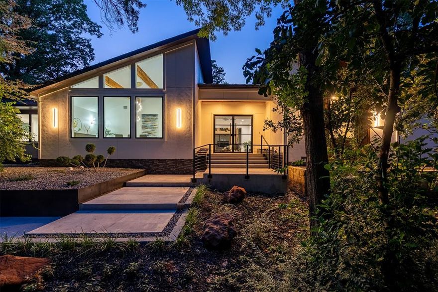 This exquisite residence is nestled among the trees on one of Kessler Park's most iconic streets, just moments from the vibrant heart of Dallas & is a perfect blend of sophistication, modern style, and luxury, situated on a lush, heavily wooded lot. The open floor plan seamlessly connects multiple living areas, ideal for gatherings. Elegant formal dining offers spectacular views. The expansive kitchen, with a prep kitchen and a large island adorned with a unique, nature-inspired countertop, is a culinary masterpiece. 
Step outside to your private oasis, featuring a heated pool, jacuzzi, outdoor kitchen, fire pit, & ample grassy space to enjoy this hilltop haven. The owner's suite is a sanctuary, boasting a spacious bedroom that leads to a magnificent bathroom with double vanities, a frameless glass twin shower, an elegant stand-alone tub, and a generous walk-in closet. This home is your unique sanctuary, harmonizing luxury and nature in one extraordinary setting.