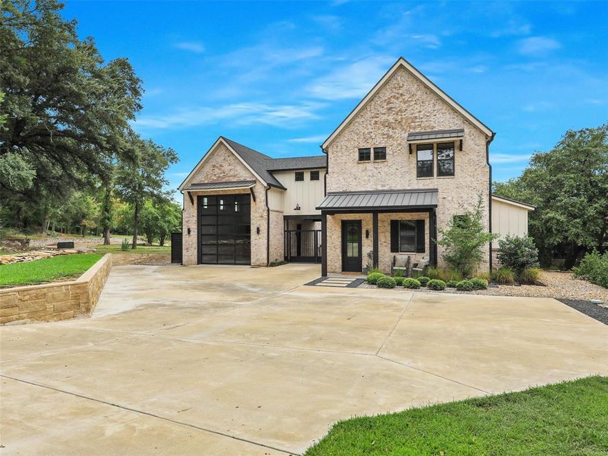 Modern Lakehouse Style on a private 2 ac lot on Lake Granbury! Features open floor plan, abundant light & clean line modernity complemented with transitional style through the use of flat panel contemporary cabinetry with German smeared exposed brick walls & French doors. An oversized kitchen island opens to the dining & living room, all overlooking backyard & lake. Office doubles as bunk room with adjacent full bath. Upstairs are 3 bedrooms including primary suite with spectacular views. Spacious en suite bath houses a long double vanity, enormous shower & separate soaking tub.  Pine white washed floors are paired with black matte industrial style fixtures in a contemporary style. 
A separate guest suite attached to garage includes living, kitchen & upstairs separate bedroom with full bath. 
Excellent flow from wrap around porch to pool & spa, open patio with fireplace & large backyard. A rustic walking path leads to a deepwater dock with boat & watercraft slips in private cove.
New roof November 2024.