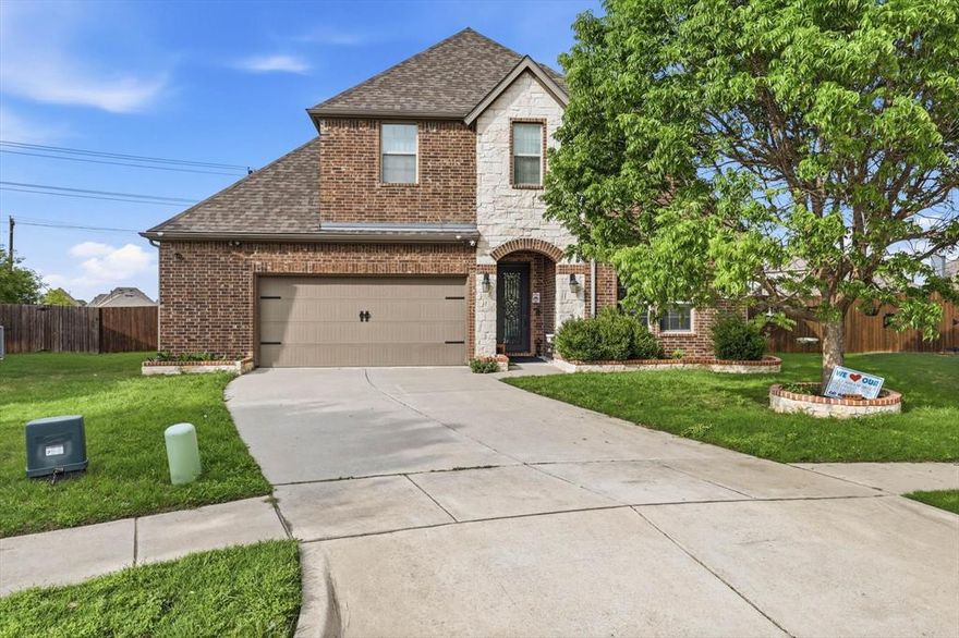 Best of both worlds—McKinney address with highly sought-after Prosper ISD! Nestled on a quiet cul-de-sac, Nestled on a quiet cul-de-sac, this stunning home welcomes you with a striking metal and glass front door that adds an immediate touch of luxury, complemented by eye-catching stone elevation. Numerous upgrades throughout - Elegant tile flooring flows through the entry, dining, living, and kitchen areas, creating a seamless and modern feel. The open-concept layout showcases a beautifully upgraded kitchen with stylish glass backsplash overlooking the spacious living room, highlighted by a dramatic floor-to-ceiling tiled fireplace with illuminated accent showpiece columns. The private primary suite offers a luxurious custom closet, while a downstairs guest suite with an adjoining full bath provides ideal flexibility. A dedicated study with French doors completes the first floor. Upstairs, enjoy a large game room, media room, and two generously sized bedrooms with walk-in closets. Additional highlights include an oversized 2-car garage with three overhead storage racks and an extended curved patio—perfect for outdoor entertaining.