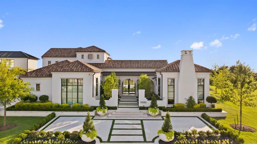 This exceptional corner-lot residence is gracefully surrounded by two acres of lush HOA green space, set deep within the prestigious guard-gated enclave of the Hills of Kingswood. Thoughtfully designed courtyards anchor both ends of the home, one offering a warm welcome, the other inviting you to stay a while. Symmetry and sophistication define the exterior. Manicured landscaping frames a pool that feels as though it glides rather than rests. The home’s east-facing orientation welcomes soft morning sun and allows natural light to pour in throughout the day, enhancing the home’s warmth and brightness. Inside, the experience unfolds through a dynamic play of light and shadow. Coffered ceilings float above paneled walls, and statement marble fireplaces casually steal your attention. Ralph Lauren lighting and Kallista bath fixtures elevate the interiors, while bespoke millwork and refined finishes speak to a level of craftsmanship rarely seen today. A standout feature of this residence is the secondary primary suite privately positioned with its own dedicated entrance. Inside, a custom fireplace sets a wonderful ambiance, complemented by a bar with built-in cooling fridge, marble clad en-suite bath, and a discreet Miele washer and dryer for effortless convenience. It’s the perfect space for long-term guests, multigenerational living, or an elevated work-from-home retreat. Smart home technology is seamlessly integrated throughout. A whole-home water filtration system, hard-wired security, a storm shelter built into the foundation slab, and a standby generator provide both comfort and confidence. The kitchen is architecturally sharp, designed with purpose and presence. Every fixture, every finish, every subtle shadow contributes to the feeling this extraordinary residence has. There’s a quiet power here. A calm rhythm. A sense that everything is exactly where it belongs.