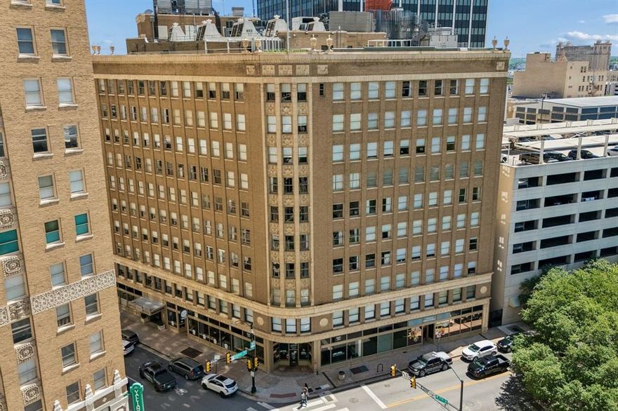 Experience elevated urban living in the iconic Neil P. at Burnett Park, where historic charm meets modern sophistication in the heart of vibrant Fort Worth. This stunning 1-bedroom, 1 full bath, 1 half bath condo offers breathtaking views of Burnett Park and 7th Street, placing you steps away from premier dining, shopping, entertainment, and theater. Inside, an expansive open-concept layout welcomes you with rich hardwood flooring and a spacious living area designed for both relaxing and entertaining. The gourmet kitchen is beautifully appointed with a large breakfast bar, granite countertops, and stainless steel appliances, creating the perfect blend of style and function. The luxurious primary suite is a private retreat featuring oversized windows with serene park views, filling the space with natural light. The spa-inspired ensuite bath boasts dual sink, granite countertops, a separate garden tub, and a separate walk-in shower, offering comfort and elegance in every detail. Residents enjoy premium conveniences including secure key fob entry, dedicated basement storage, and assigned leased parking on the 7th floor. Resort-style amenities elevate the experience even further with a large outdoor pool and spa, plus an inviting outdoor kitchen and entertainment area perfect for hosting family and friends.  Offered below a recent appraisal of $380,000, this exceptional residence presents a rare opportunity for immediate equity in one of Fort Worth’s most iconic addresses. Come experience the sophistication, style, and excitement of life at The Neil P. at Burnett Park.