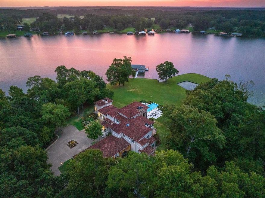 Presenting Peninsula Point, located in the heart of an exclusive enclave on Lake Tyler, this estate with an impressive ~1000 feet of shoreline is set on 3.474+ - acres. The Mediterranean-style residence is accessed through a gated entry, leading to the circular motor court. The home encompasses 6,748 sq. ft. of distinguished living space, the floor plan includes 5 bedrooms, 5 full and 2 half baths across 2 levels, 5 fireplaces, as well as an office, workout room and multiple living areas. The exterior hosts pool, manicured grounds and a covered outdoor living area with refreshment area including sink, grill and fireplace making for a central hub for outdoor gatherings. The boat house offers 3 boat slips and 2 jet ski slips, covered and open lounging spaces and an enclosed kitchen and storage space. With the deepest of water and sweeping views, the lovingly maintained grounds create the experience of the best in lake living just 90 miles east of the Dallas metroplex.