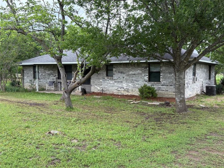 Interior pictures coming soon.
Located only 5 miles west of Sulphur Springs is this traditional 3 bedroom brick home on 26.5 ag exempt acres. The house has beautiful wood cabinets, pantry, stove, refrigerator and microwave. The living room features a wood burning fireplace with split bedrooms. A large  12x21' covered patio on the back overlooking the acreage and 2 ponds. The entire property is fenced with cross fence and a few barns for livestock and storage. The 2 ponds allow for adequate surface water in each pasture,  while the acreage provides plenty of grazing for large animals. The large yard contains many types of trees with plenty of room for a garden spot, chickens or a few smaller animals. Located just off Hwy 11 providing easy access  to Sulphur Springs, Commerce or I30.
There is plenty of room for an additional home, tiny home or mobile home. NO KNOWN RESTRICTIONS allow you to do it your way.