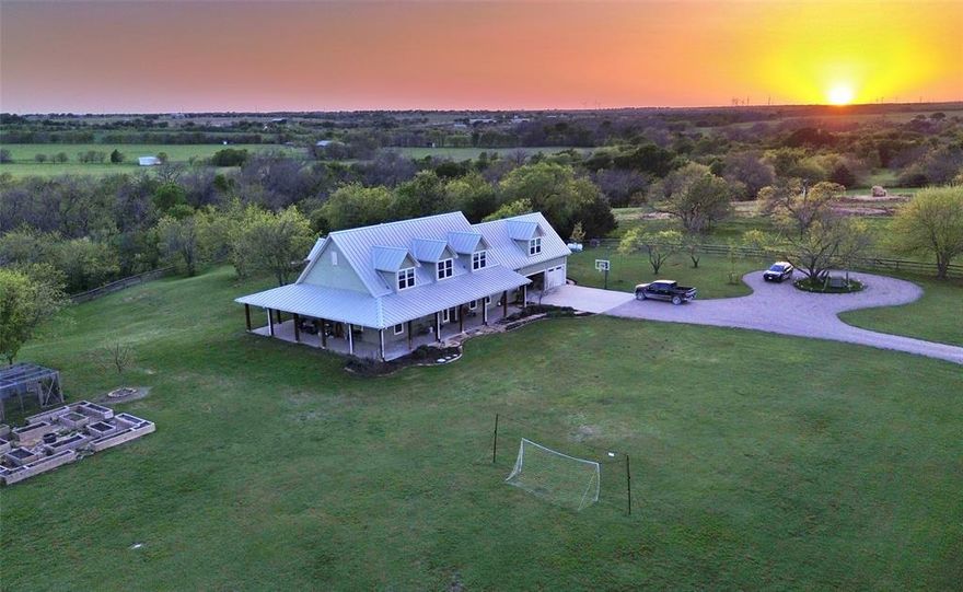Great stock farm located between Gainesville and Valley View, TX only one mile west of Interstate 35.  Property hosts both Spring Creek and Willow Creek. Custom entry gate with electronic openers that allow access to the long driveway to the house.  Thoughfully designed custom home made for family enjoyment.  Perched upon the highest point on the property, the home overlooks the Willow and Spring Creek bottoms below.  The 2.64 acre fenced yard and cattle guard keeps the cattle far enough to avoid the smells, but close enough to enjoy the sight.  The three car garage has ample room for your vehicles and side-by-side, while the concrete approach offers a place to play a little basketball.  You'll notice right away that the wrap around porch along with the pool, hot tub,stone fire pit and cabana are the key features for outdoor living at the ranch.  Also in the yard are two large, very nice chicken pens as well as a raised bed garden.  The irrigation system keeps the yard healthy and green all summer.   Just a short walk from the home is a new 40x60 all metal shop with drive-through doors, lighting, and ample number of 110v and 220v plugs. The home, built in 2018, has 3,407 square feet with 2 bedrooms and 2 bathrooms down stairs, and 2 bedrooms, 2 bathrooms, and a game room located upstairs.  All common areas of the home have a vinyl plank wood-look flooring, while the bedrooms have carpet and the bathrroms have tile.  9' tall ceilings throughout the house, with large baseboards and crown moldings.  The chef's kitchen is open to the living room, and has a large 5x8 granite topped island, a 4x7 walk-in pantry, a coffee bar, double oven and gas stove.   The windows over look the valley as well as the pool area.  The corner fireplace in the living room is sure to keep you warm on those cold winter nights.  Go into the three car garage, and you will find a staircase that leads to secluded private office above the garage.