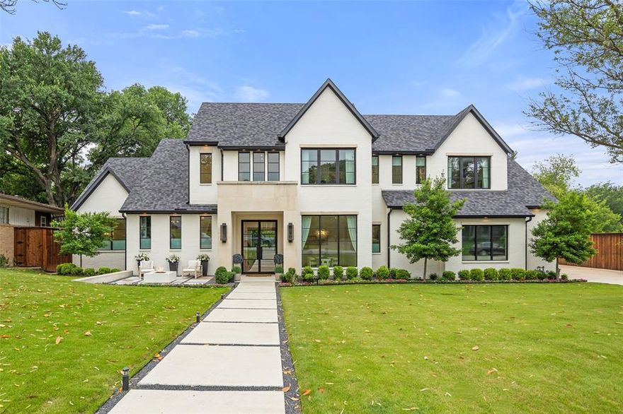 Exquisite custom-built luxury home nestled on a lush 0.47-acre lot in a prime location—just a short walk to TCU, near Colonial Country Club, and zoned to Overton Park Elementary. This stunning residence offers an open, light-filled floor plan with soaring ceilings and expansive windows throughout. A grand two-story entryway leads to an elegant dining room and spacious living area centered around a beautiful fireplace, flanked by floor-to-ceiling built-ins. The dining room connects to the chef’s kitchen via a convenient serving pantry. The gourmet kitchen is designed for entertaining, featuring a commercial-grade gas range, oversized island, custom cabinetry, and a sunlit breakfast room. Large stacking sliding doors create seamless indoor-outdoor living, opening to a heated covered patio with a built-in grill, fireplace, and views of the private backyard—complete with a basketball court and generous green space. The three-car garage with epoxy floors opens into a mudroom with built-in lockers, leading to an oversized laundry room with additional storage. The first-floor primary suite is a serene retreat with a spa-like bath and custom walk-in closets. Upstairs, a spacious second living room and a media room offer plenty of space for relaxation. Three additional bedrooms each have walk-in closets, and a versatile bonus room provides the perfect space for a home office, gym, or playroom.