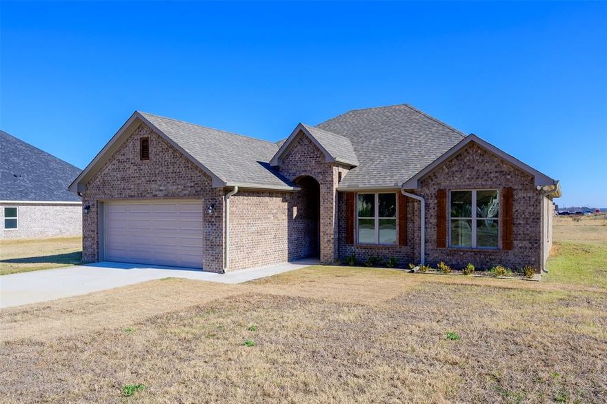 Brand New Home in Lindale ISD situated on an expansive half-acre lot that effortlessly fulfills all your criteria: affordability, a thoughtfully designed floor plan, a generous yard and a total of 4 bedrooms! Upon entering, you'll be welcomed by wood-look tile flooring that seamlessly extends throughout and is complemented by sophisticated crown molding. The entire space is well-lit with LED lighting and each bedroom, as well as the living room, is equipped with ceiling fans for enhanced comfort. The home is adorned with custom-built cabinets featuring contemporary hardware, showcasing impeccable craftsmanship. The kitchen boasts ample counter space and a central island housing the sink, dishwasher, and a dedicated trash cabinet. The master bedroom is strategically positioned for privacy and convenience, featuring an exterior door leading to the back porch, an en-suite bathroom with double sinks, a separate shower and tub, and a walk-in closet with meticulously crafted trim work!