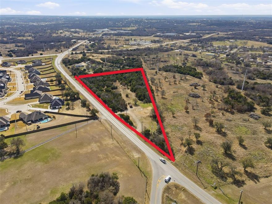 3.902 acres just off of Ric Williamson Loop on Zion Hill Rd.  Apx. 815 ft of road frontage on FM 2421 aka Zion Hill Rd with TxDot average daily traffic count at 5,384 on Zion Hill Rd and 10,332 from FM 51 to Zion Hill. Sandy soil with apx half the property brush and trees. Apx. 1 acre is in the city limits and the remainder in the county with no restrictions. The portion that is in the city is zoned agricultural and or residential but that zoning includes church, day care, vet clinic, school, etc.  See city website for full list of uses.  Well, septic and an electric pole are on property.  Will need to do due diligence and work with the city in regard to the zoning requirements on the portion of the property that is in city limits.