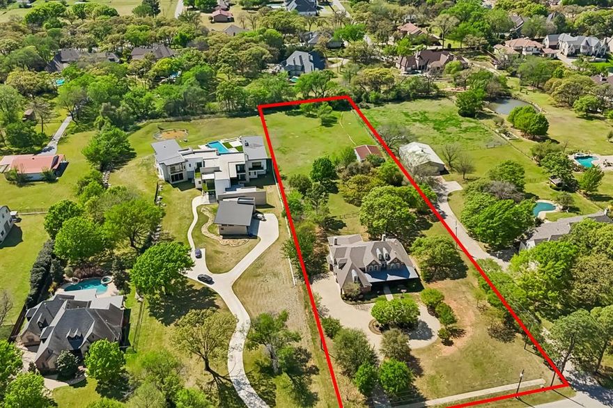 Discover the ultimate canvas for your dream home located on the desirable Bill Simmons Road.  Spanning over 2.3 acres, this property is perfectly nestled at the end of a peaceful cul-de-sac, offering unmatched privacy. The true value lies in the land itself, which includes an existing 4,407sf home and bonus 30x40 barn. You can live in the existing home while you build your Dream Home. This gorgeous property provides endless possibilities. Whether you envision a custom home or a charming renovation this is the perfect setting.  Easy access to premier shopping, dining, entertainment and minutes away from DFW International Airport. NO HOA restrictions, you have the freedom to design and build on this serene, private setting.
