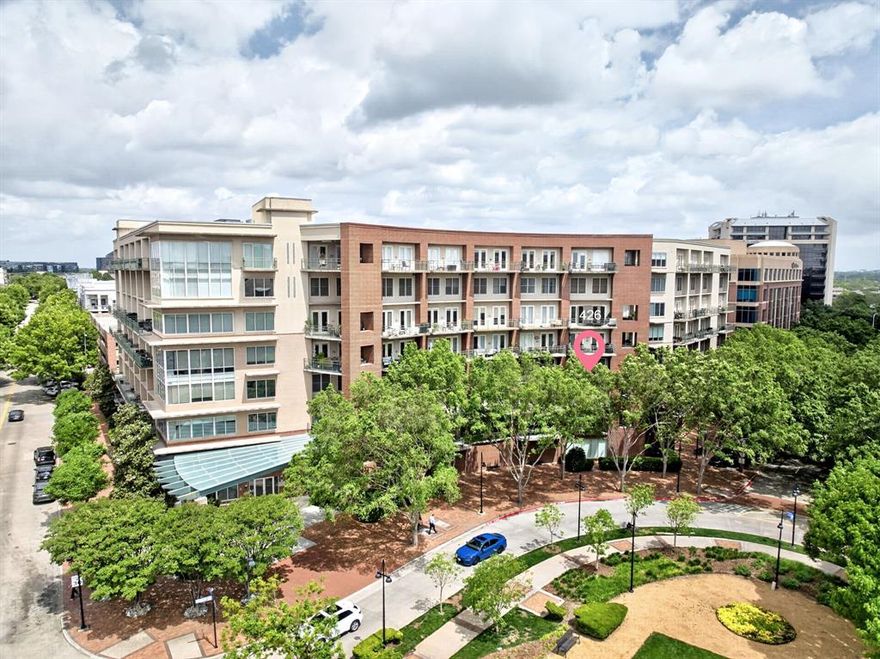 Discover Urban Elegance in the Heart of Addison with this exquisite 2-bedroom, 2-bathroom residence. This beautifully appointed home offers a seamless combination of modern luxury and timeless style with an abundance of natural light and premium finishes throughout.  Upon entering, you are greeted by rich oak hand-scraped floors that extend through the living spaces, accompanied by a stunning custom-designed banister. The living area is adorned with majestic wood ceiling beams, lending a sense of rustic elegance. Floor-to-ceiling windows not only flood the interior with natural light but also provide unobstructed views of the serene surroundings.  The gourmet kitchen is a chef's dream, featuring soft sage cabinetry with distressed finishes and complemented by exotic granite countertops. An inviting island and classic farmhouse sink provide both functionality and charm. State-of-the-art commercial appliances, including a stainless steel Viking range and Thermador dishwasher, ensure culinary endeavors are met with ease.  Both Bedrooms offer tranquil retreats, enhanced by expansive windows that welcome morning light. Retreat to the primary suite where comfort meets luxury in the well-appointed bathroom with designer finishes.  Step outside to find two private balconies, perfect for unwinding while enjoying picturesque views of the community pool and the lush landscape of Beckert Park. The location offers an array of amenities beyond the home, with Addison Circle Park just a short stroll away, hosting vibrant festivals throughout the year. Indulge in an array of dining establishments and boutique shops, all within walking distance, ensuring that the best of Addison is always at your doorstep.  With 2 assigned parking spots convenience is matched by the vibrant lifestyle this residence affords, making it a truly exceptional offering in one of Addison's most sought-after locations. HOA includes Water, Gas, Pest Control, Internet, Cable, Concierge Services, trash and more.