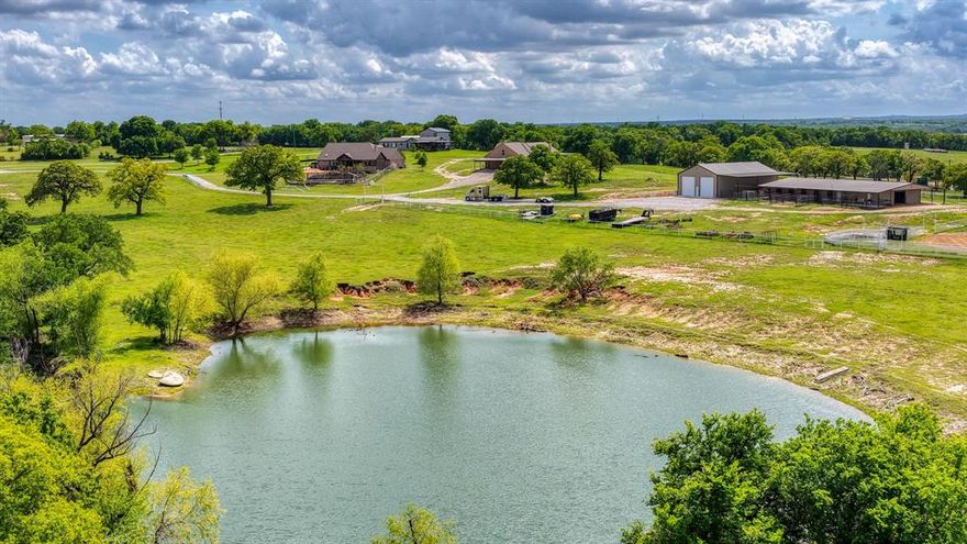 Salt Creek Ranch – Premier Equine Estate Near Fort Worth

Salt Creek Ranch is an exceptional 165-acre equine property located just minutes from Fort Worth, Texas. Designed with multi-generational living in mind, this remarkable ranch is a rare combination of natural beauty, functionality, and top-tier equestrian amenities.
Nestled among the rolling hills of Wise County, the land is rich in water resources and covered in high-quality coastal Bermuda grass. The property features 11 expansive ponds stocked with bass and catfish, along with an abundance of mature oak trees providing natural shade for livestock.
At the heart of the ranch, the equine facilities are thoughtfully designed to meet a variety of needs. The main barn includes 10 horse stalls, a wash bay, bunkhouse, tack room, and 10 well-maintained turnouts. The arena is fully equipped with calf returns, roping boxes, a head chute, and sandy soil—ideal for training and performance. The ranch is fenced and cross-fenced with precision, offering catch pens for both cattle and horses, each with convenient access to water. Water infrastructure is a standout feature, with four high-producing wells supporting both agricultural and ranching operations.
Salt Creek Ranch offers three primary residences: A beautifully appointed 4-bedroom, 3-bath brick home featuring a pool and breathtaking views. 
A second 5-bedroom, 3-bath brick home with stunning sunset vistas. A spacious, expanded doublewide home offering 5 bedrooms and 3 baths
Additional improvements include a dedicated gathering house with kitchenette and bath—perfect for hosting holidays and events—and a metal office building near the main entrance, previously used for K-9 grooming. This is a rare opportunity to own a ranch of this caliber in close proximity to the Dallas-Fort Worth metroplex—offering the perfect balance of privacy, productivity, and convenience.