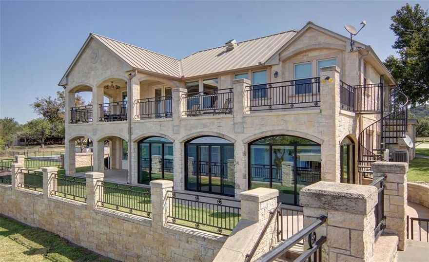 Experience unparalleled luxury in this fully furnished expansive 6-bedroom, 4-bathroom lakefront home with 3,472 sq ft of elegant living space. Enjoy breathtaking views from second story patio and direct access to a lake with 35 feet of depth beneath the dock when full. This property features level 4 granite countertops, LVP flooring, and automated blinds. Recent updates include: standing seam roof, water softener, newer HVAC, and water heaters. The heated and cooled enclosed patio seamlessly connects to the home, providing a year-round space to relax and entertain. The outdoor entertainment area features a ½ bath, stainless steel countertops, and double patio spaces. The property boasts a gated entry, a sprinkler system using lake water, and a retaining wall with direct water access. Enhance your lake experience with the 2 story dock with slide and electric lifts.