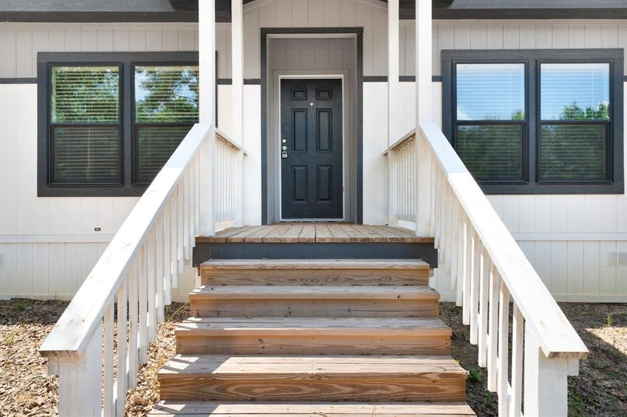 Welcome to 211 Private Road 3900 — a beautifully designed modern farmhouse nestled on 1.1 secluded acres in the exclusive Dawn Estates development. With only five homesites in the area, this peaceful retreat offers the privacy of country living while remaining just minutes from town amenities.

This 2023 model home boasts 1,440 square feet of open-concept living space, featuring 3 bedrooms and 2 bathrooms with a thoughtfully designed split floor plan. The kitchen is the heart of the home, complete with a large island, walk-in pantry, a striking stainless steel farm sink, and beautiful exposed beams that add warmth and character to the space. The primary suite offers a luxurious escape with dual sinks and an impressive 72-inch walk-in shower equipped with body sprayers, while the guest bath includes a 60-inch soaking tub.

Enjoy a charming covered front entry and an expansive covered back deck that serves as a perfect entertaining area for gatherings, grilling, or simply relaxing in the shade. Take advantage of ample storage with walk-in closets. Soaring 8.5-foot ceilings and a bright, modern aesthetic make this home feel spacious and welcoming.

Perfect for first-time buyers, growing families, or those seeking a peaceful country retreat with convenience, this property is a rare gem in Gilmer. Don’t miss your chance to call it home!