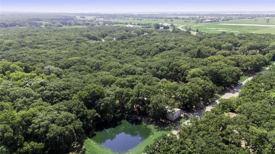 4.14 Acres – Cleared, Improved Land with Workshop & Pond – Outside the city limits.
Escape the city and build your dream home or investment property on this beautiful 3.8-acre tract located in an established, peaceful neighborhood. This cleared and build-ready property offers a rare combination of space, privacy, and functionality. Mature trees provide natural beauty and shade, while an aerated pond adds a serene and scenic focal point to the land. This property features a Large 40’ x 20’ workshop with electric, roll-up doors, and dedicated office space – perfect for business, storage, or hobbies. Custom electric entry gate adds both security and curb appeal, located outside city limits offering fewer restrictions and more freedom in a quiet neighborhood with country charm. Water and electricity on site. Mobile homes allowed. All mineral rights convey with the sale. This is a one-of-a-kind opportunity to own improved acreage with all the right features already in place. Whether you're looking to build a custom home or barndominium, place a mobile home, or create a private retreat or small business setup, this land is ready to make your vision a reality.